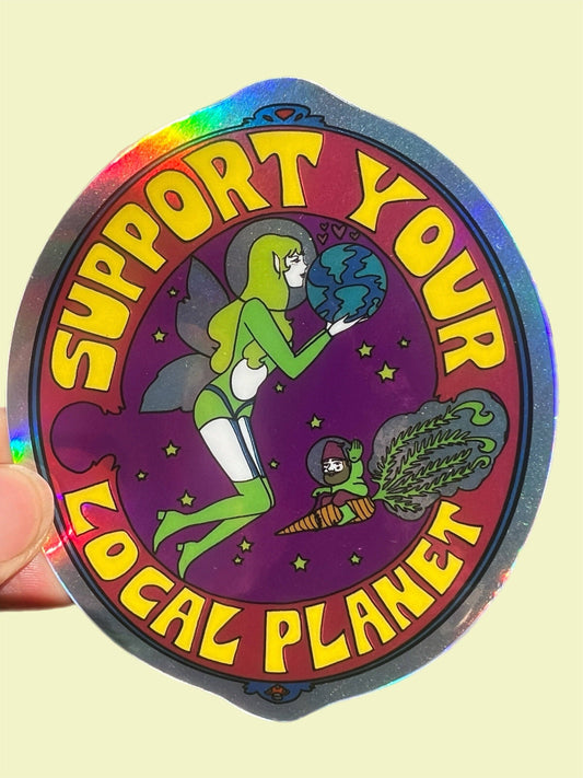 Holographic sticker with cartoon character holding Earth and text 'Support Your Local Planet' on a beige background