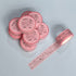 Pink washi tape with decorative design on a light gray background