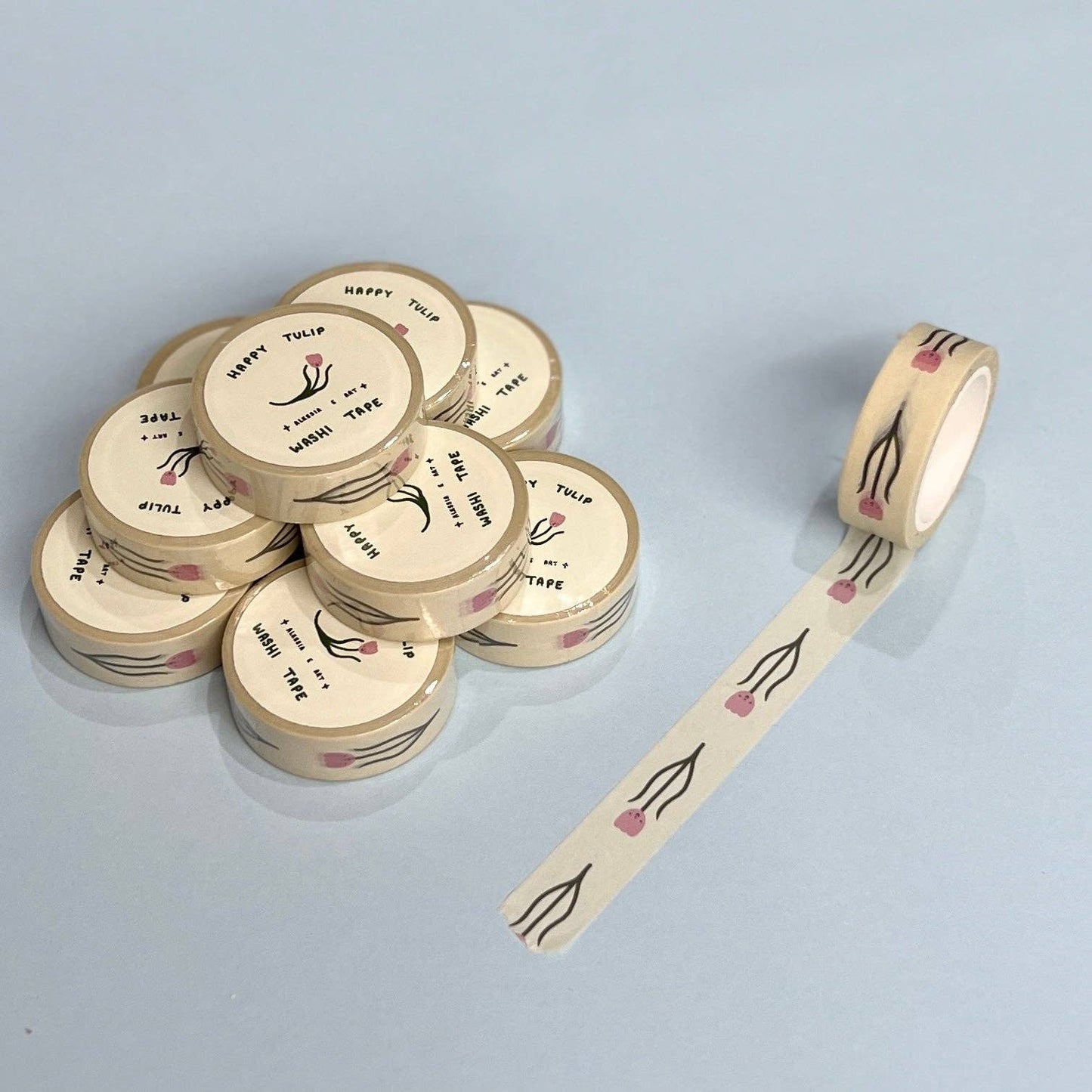 Rolls of decorative tape with floral designs on a light gray background