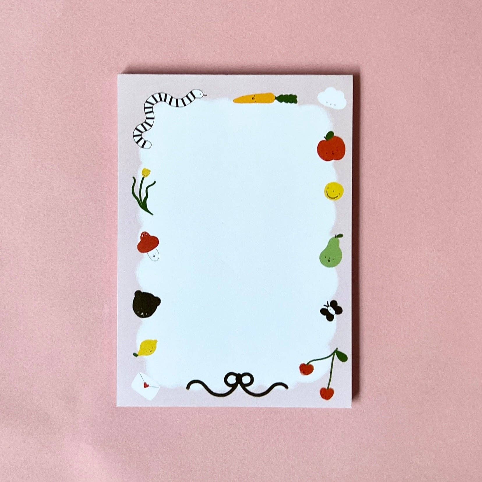 Notebook with colorful stickers on a pink background