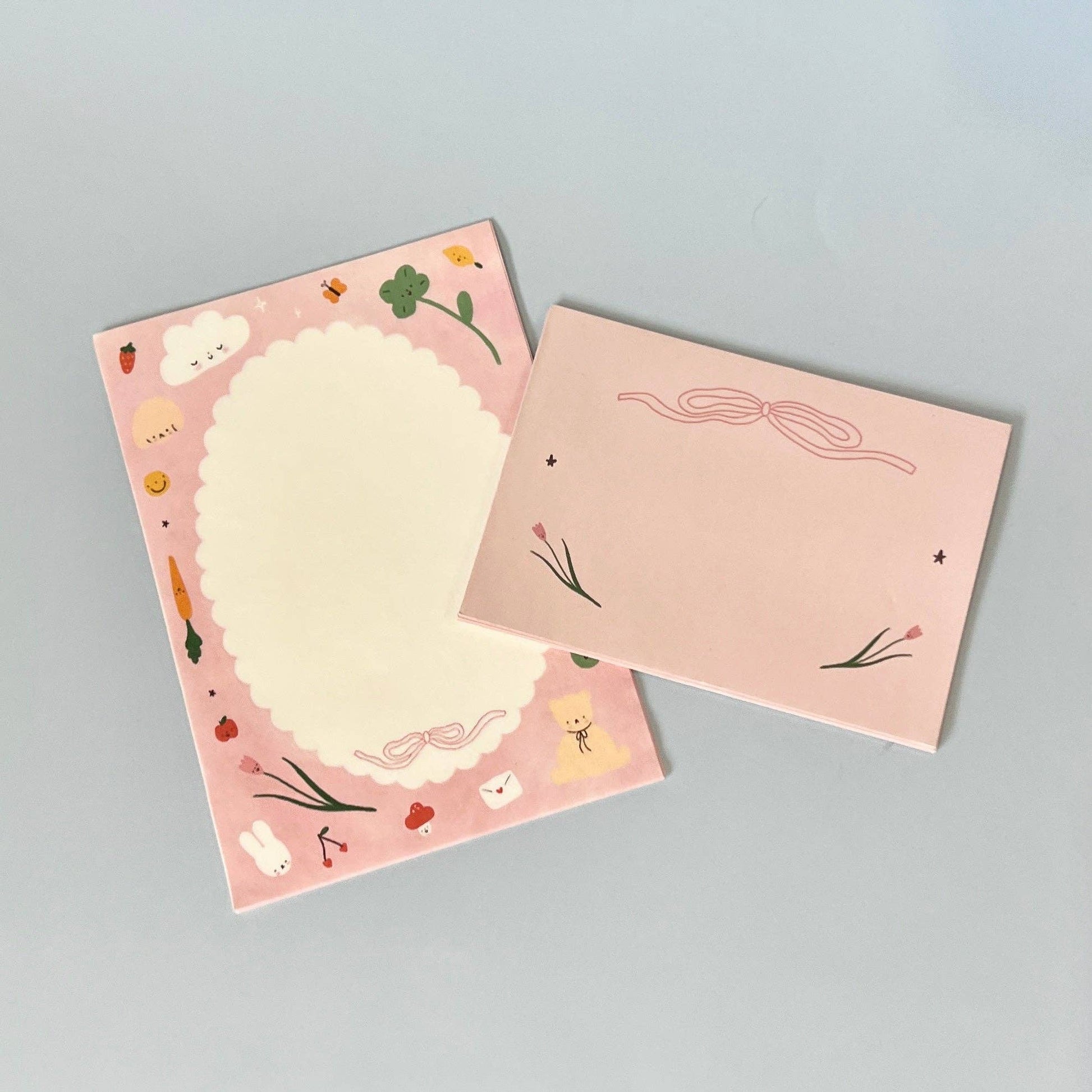 a letter and envelope with illustrations on a gray background