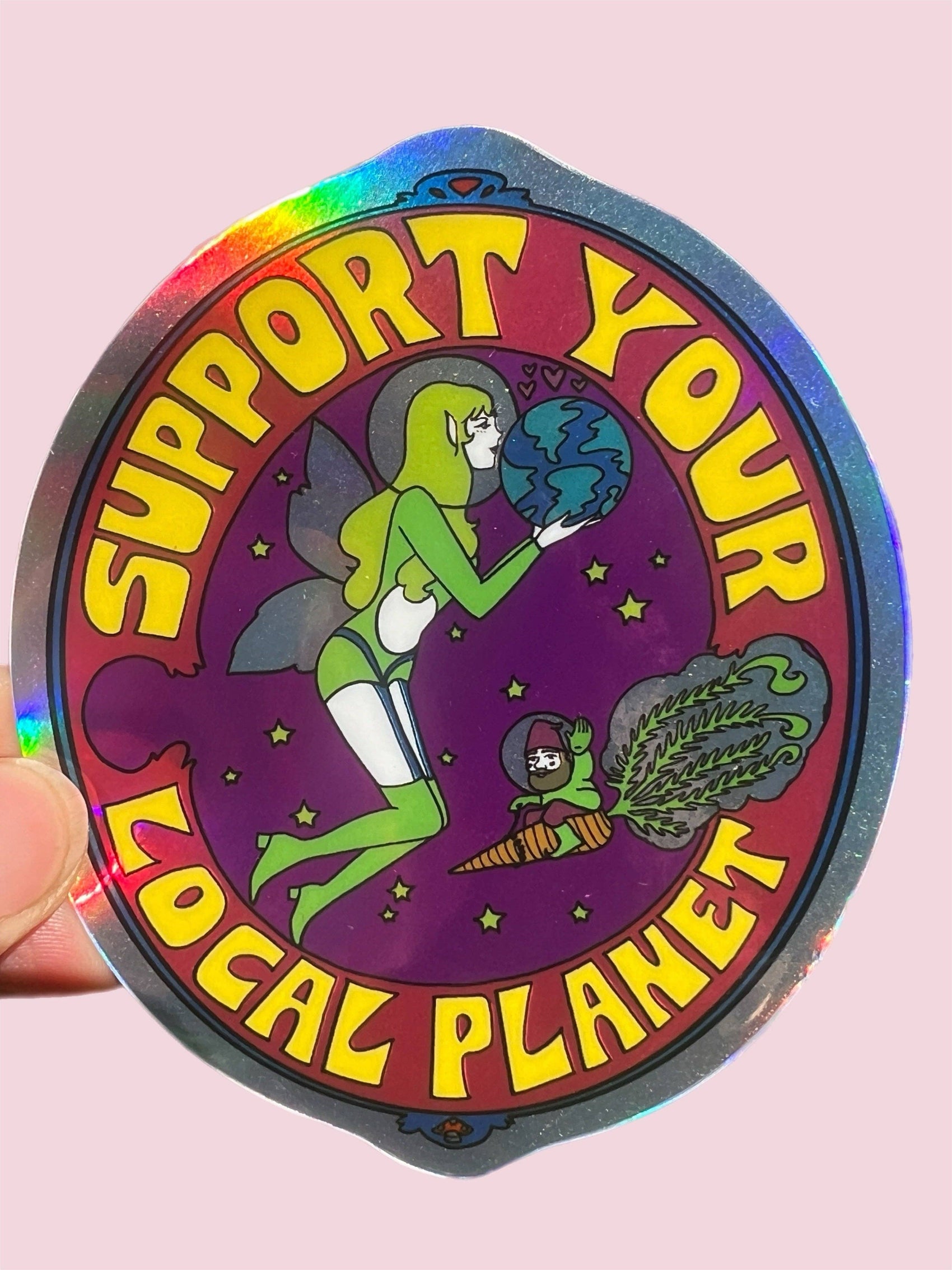 Holographic sticker with a character holding the Earth and text 'Support Your Local Planet' on a pink background.