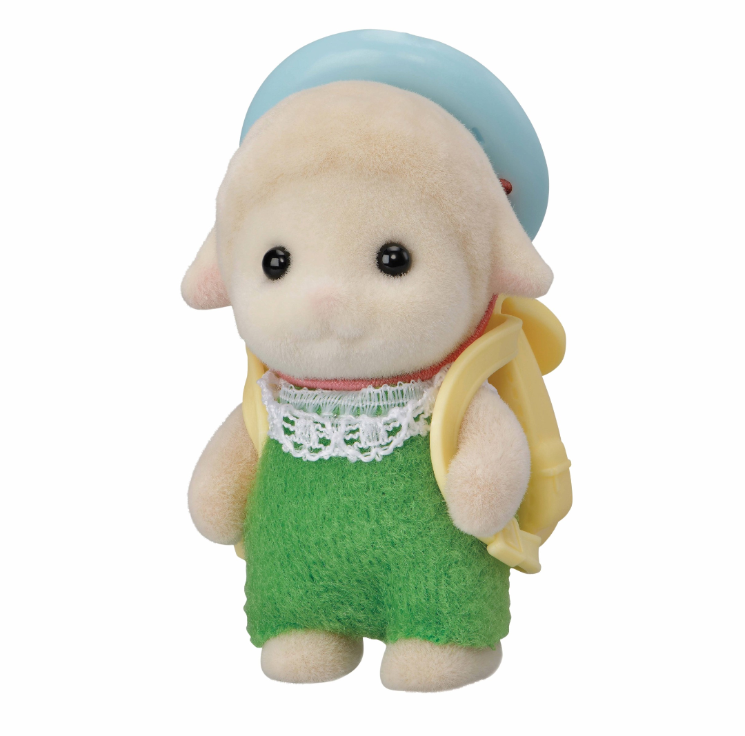 Small toy figure of a character wearing a green dress, yellow top, and blue hat on a white background