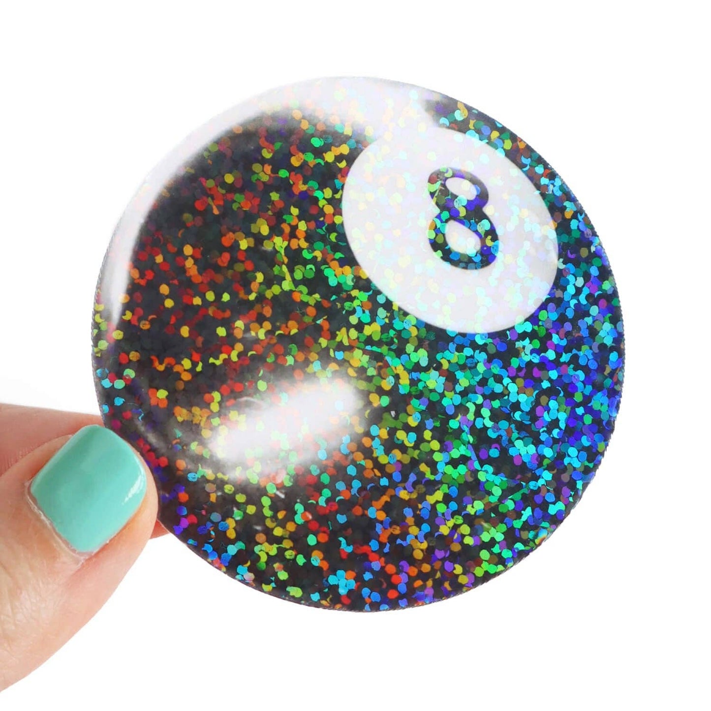glitter 8 ball sticker held by a hand against a white background