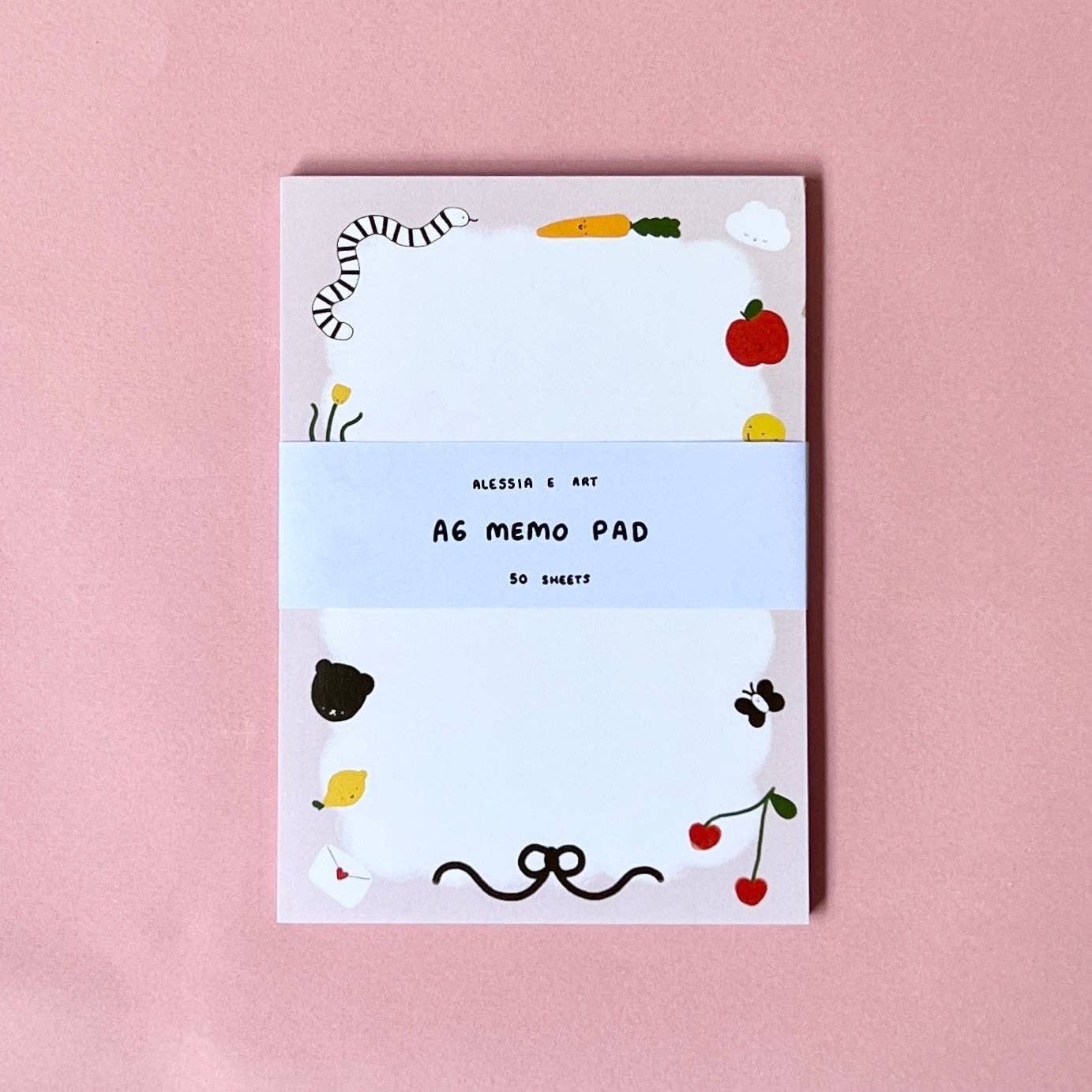 Memo pad with cute illustrations on a pink background