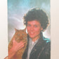 Person holding a cat with a colorful, gradient background