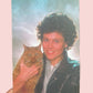 Person holding a cat on a pink background