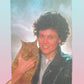 Person holding a cat with a pastel gradient background