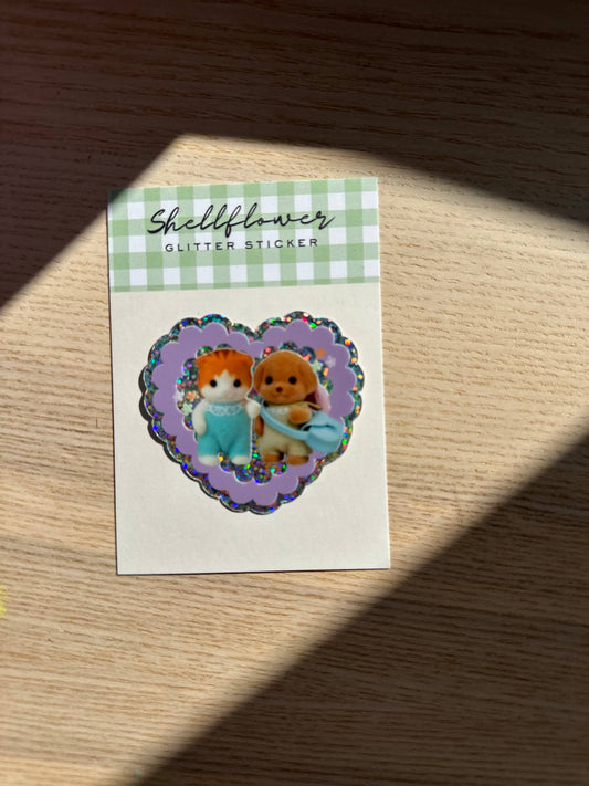 Shellflower glitter sticker with two small characters on a checkered background