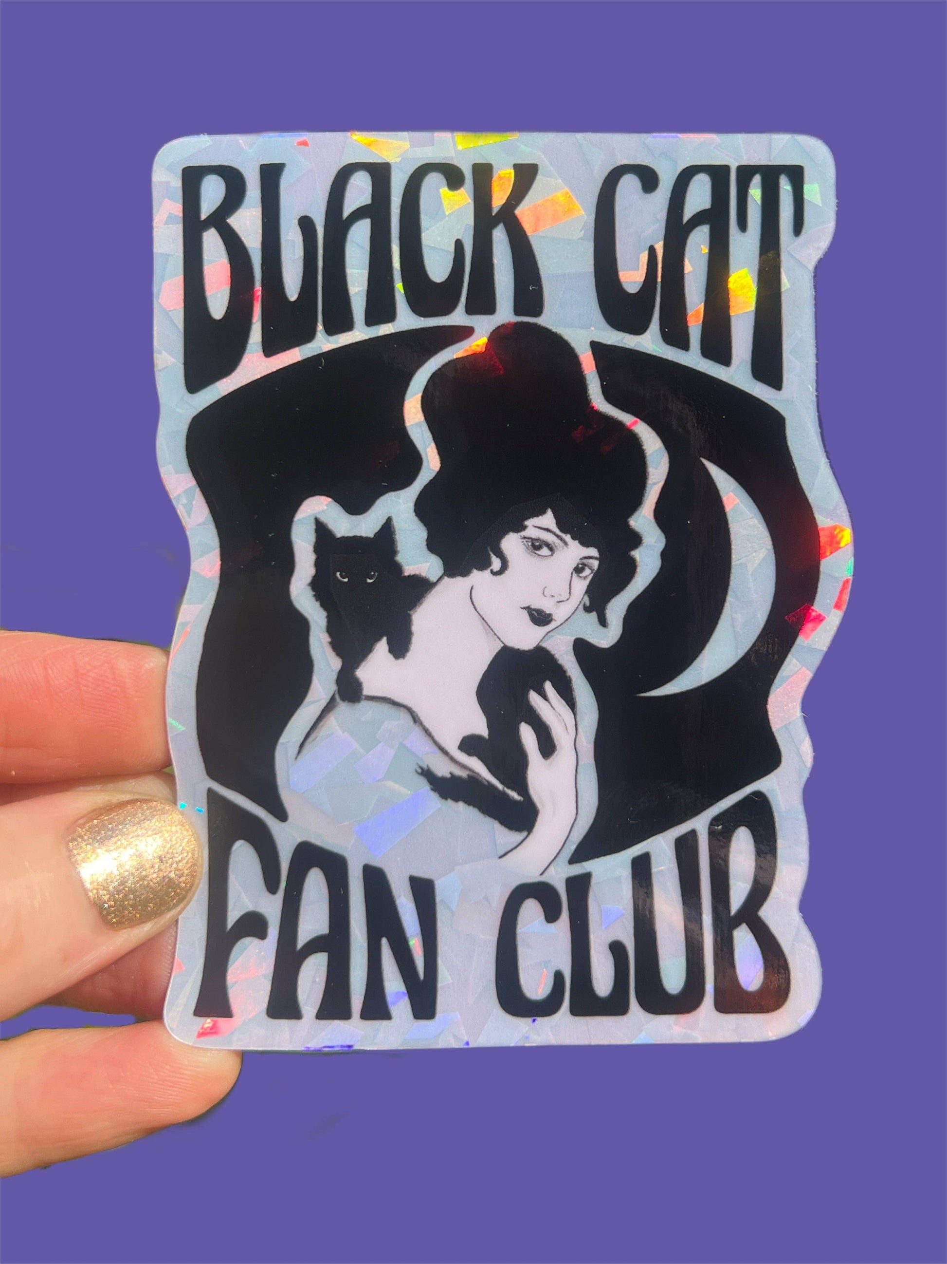Sticker with 'Black Cat Fan Club' design held against a purple background