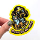 Hand holding a yellow sticker of a dog that says 'born to be mild'