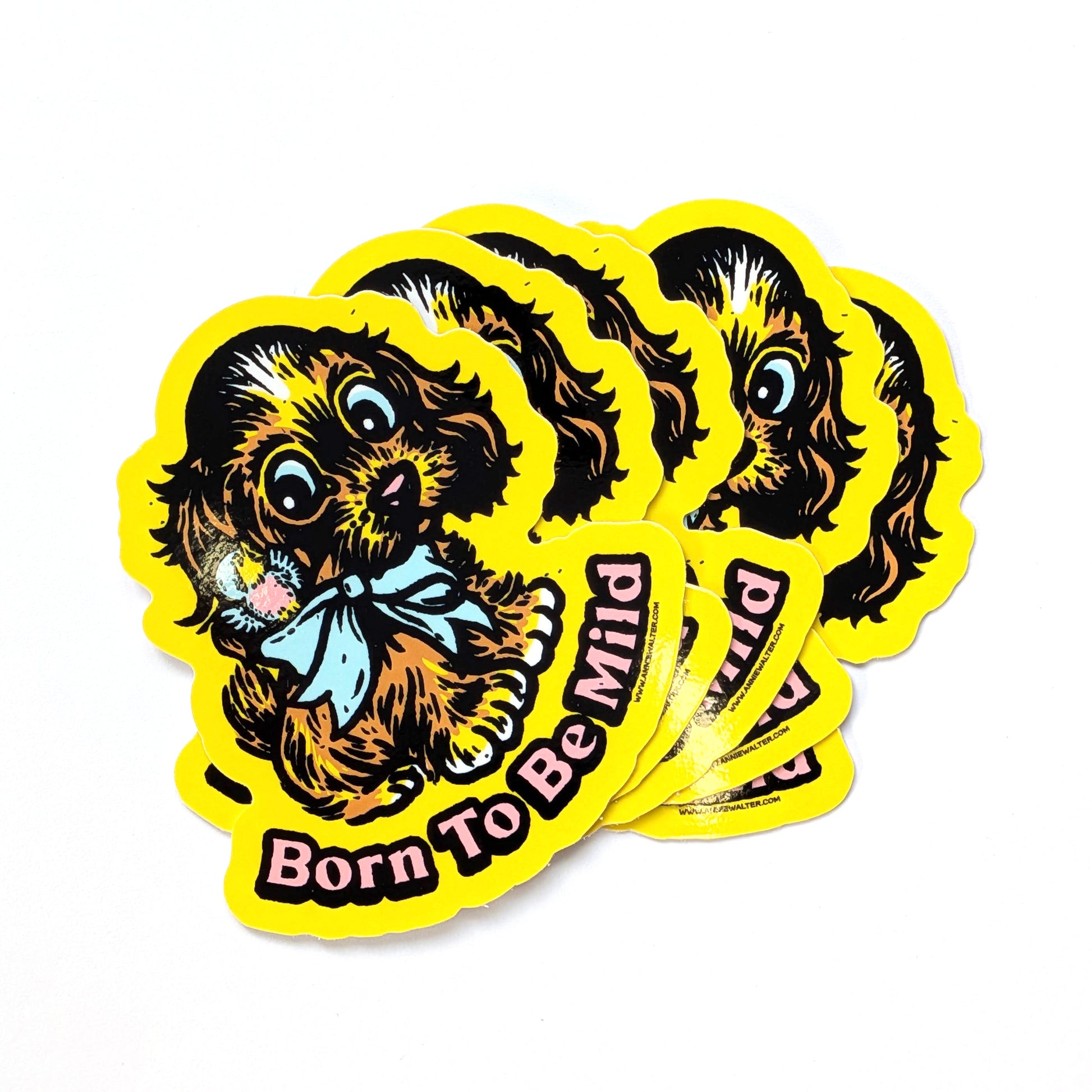 Stack of yellow stickers of a dog and the text 'Born to be mild'