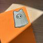 Cat sylvanian ghost glitter sticker on an orange background
