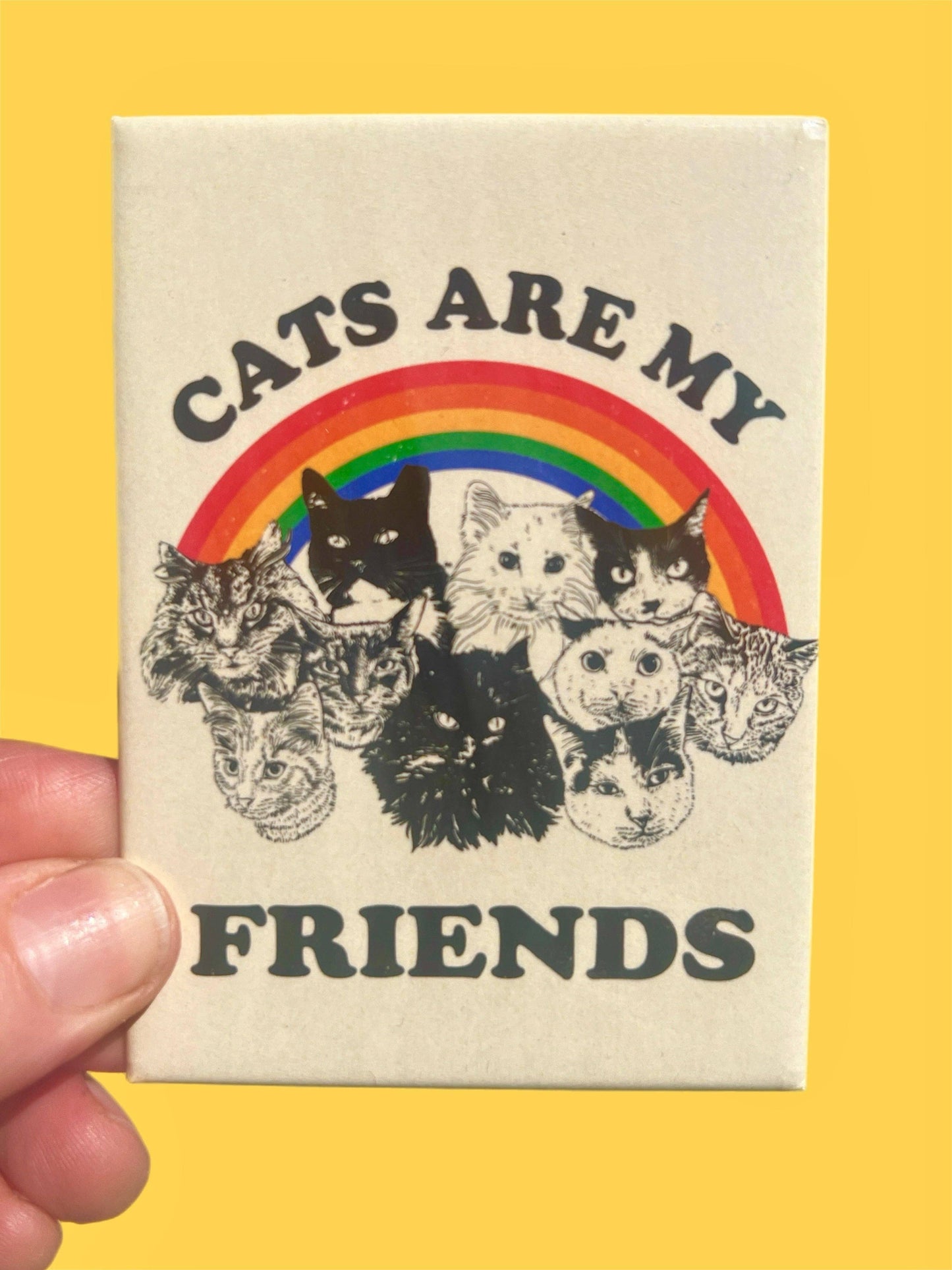 Magnet with cats and rainbow design on a yellow background