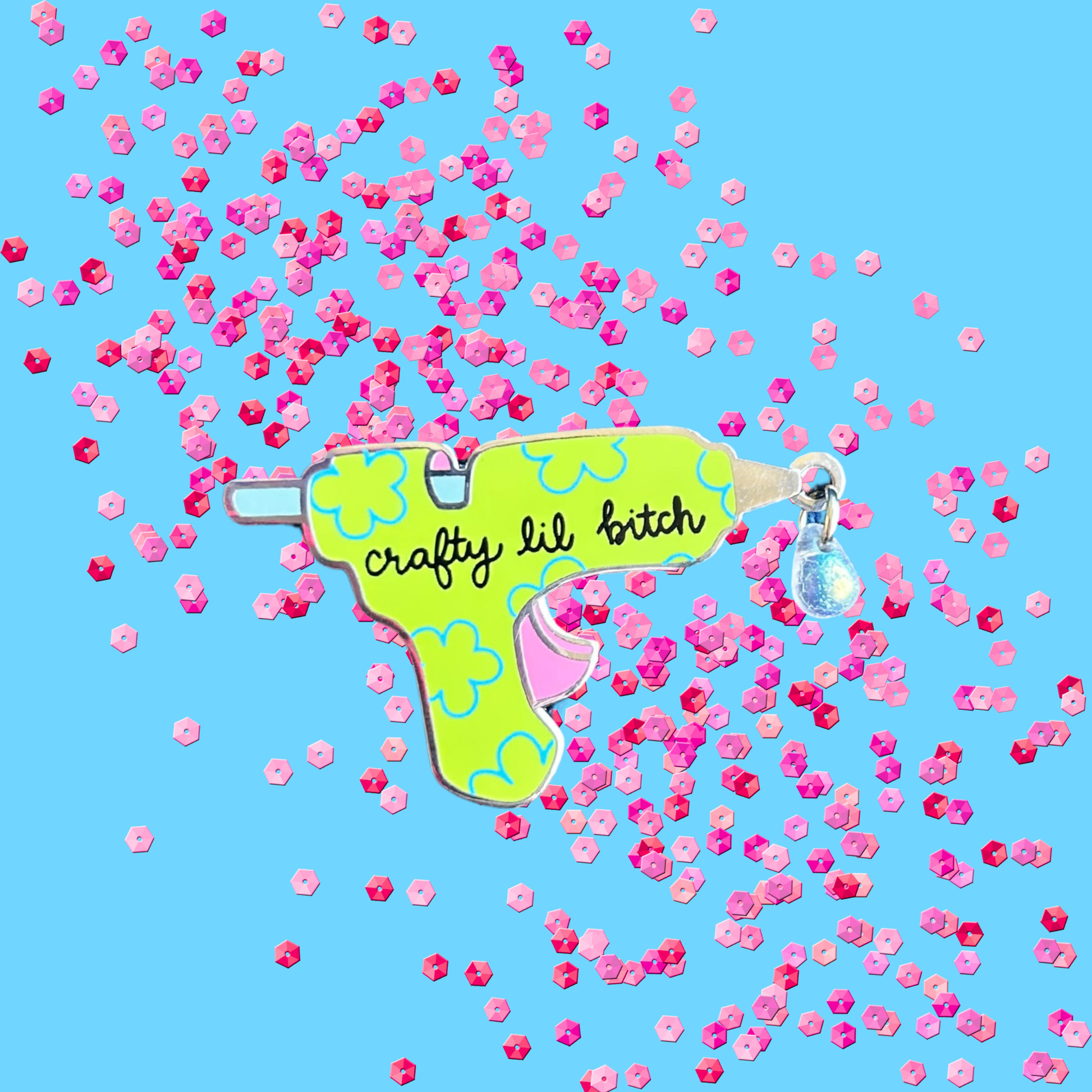 Green glue gun with text surrounded by pink confetti on a blue background