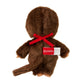 Brown plush toy with a red bow and visible brand label on a white background