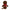 Brown plush toy with a red bow and visible brand label on a white background