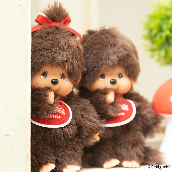 Two plush toys with brown fur and red bows, holding a tag with 'Sekiguchi' branding.