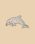 A cute cartoon dolphin sticker with pastel rainbow stripes in pink, yellow, green, blue, and purple, outlined in black with a white border, on a solid beige background.