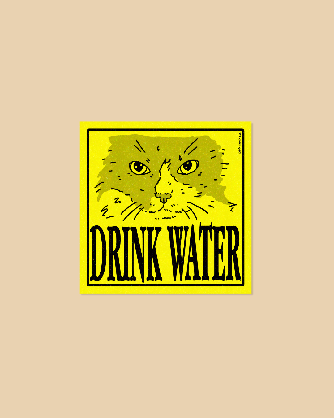 A square yellow sticker or sign featuring a stylized cat face above the words “DRINK WATER” in bold black letters, centered on a plain beige background.