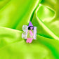 Butterfly-shaped hair clip with a fairy design on a green fabric background