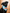 Black dog wearing a blue bandana with 'Foodie' on a wooden background
