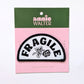 Patch with 'FRAGILE' text on a pink card with green top, featuring 'annie walter' branding.