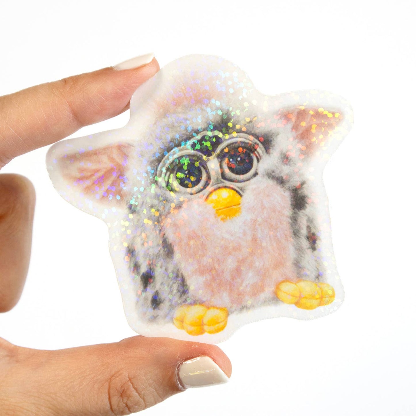 Hand holding a furby sticker