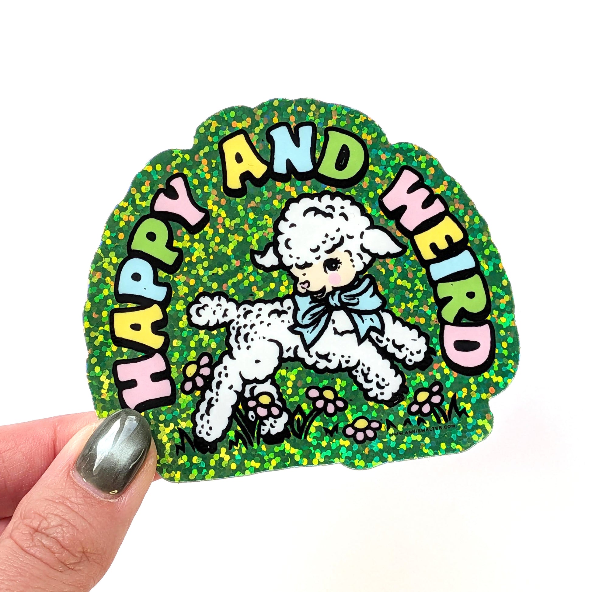 Sticker with a sheep illustration and 'Happy and Weird' text held by a hand.
