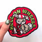 Embroidered patch with a bunny design and 'Hell on Wheels' text held by a hand.