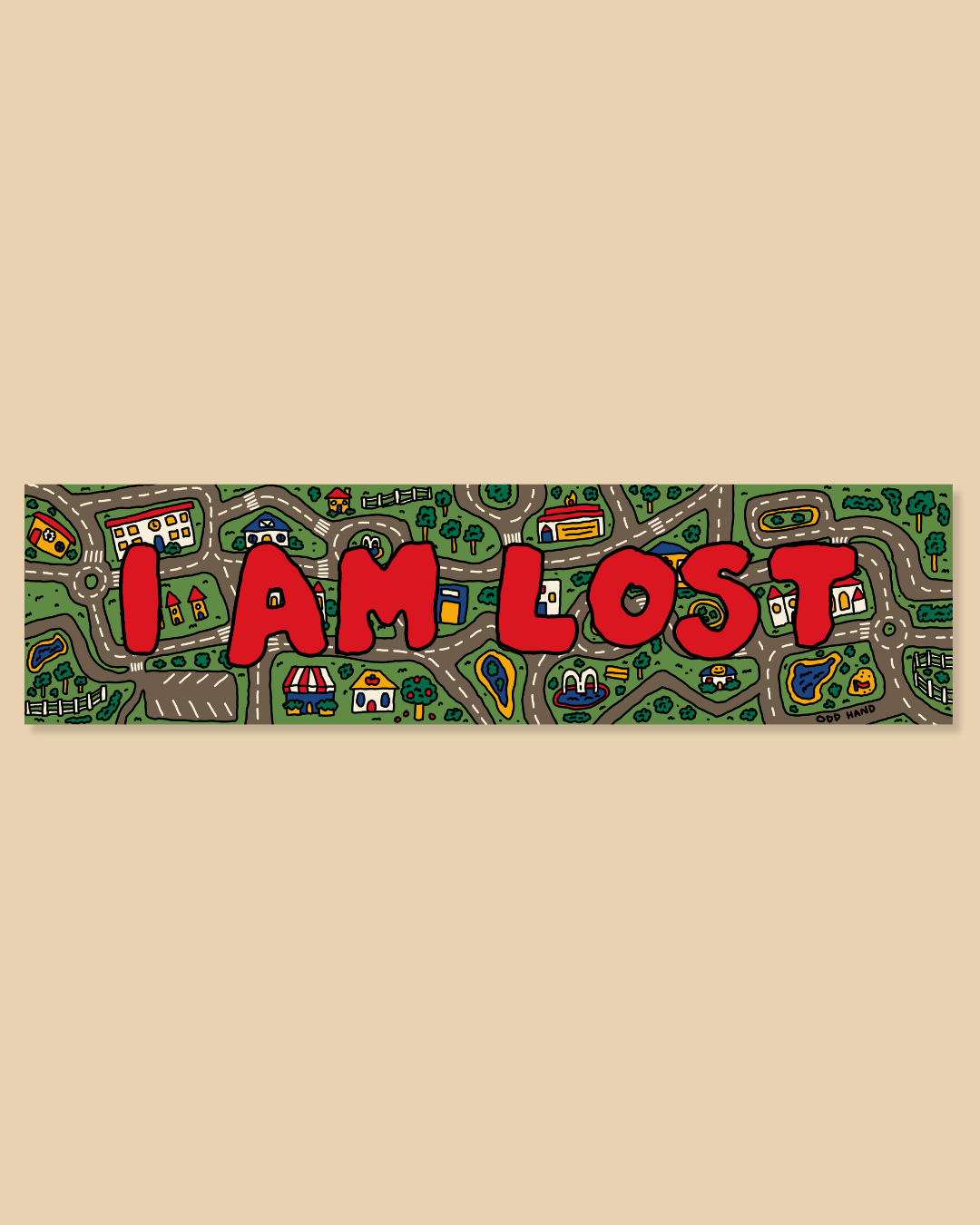 A rectangular sticker or sign featuring the phrase 'I AM LOST' in large red letters over a whimsical green map illustration with cartoon-style roads, houses, and trees, shown on a solid beige background.