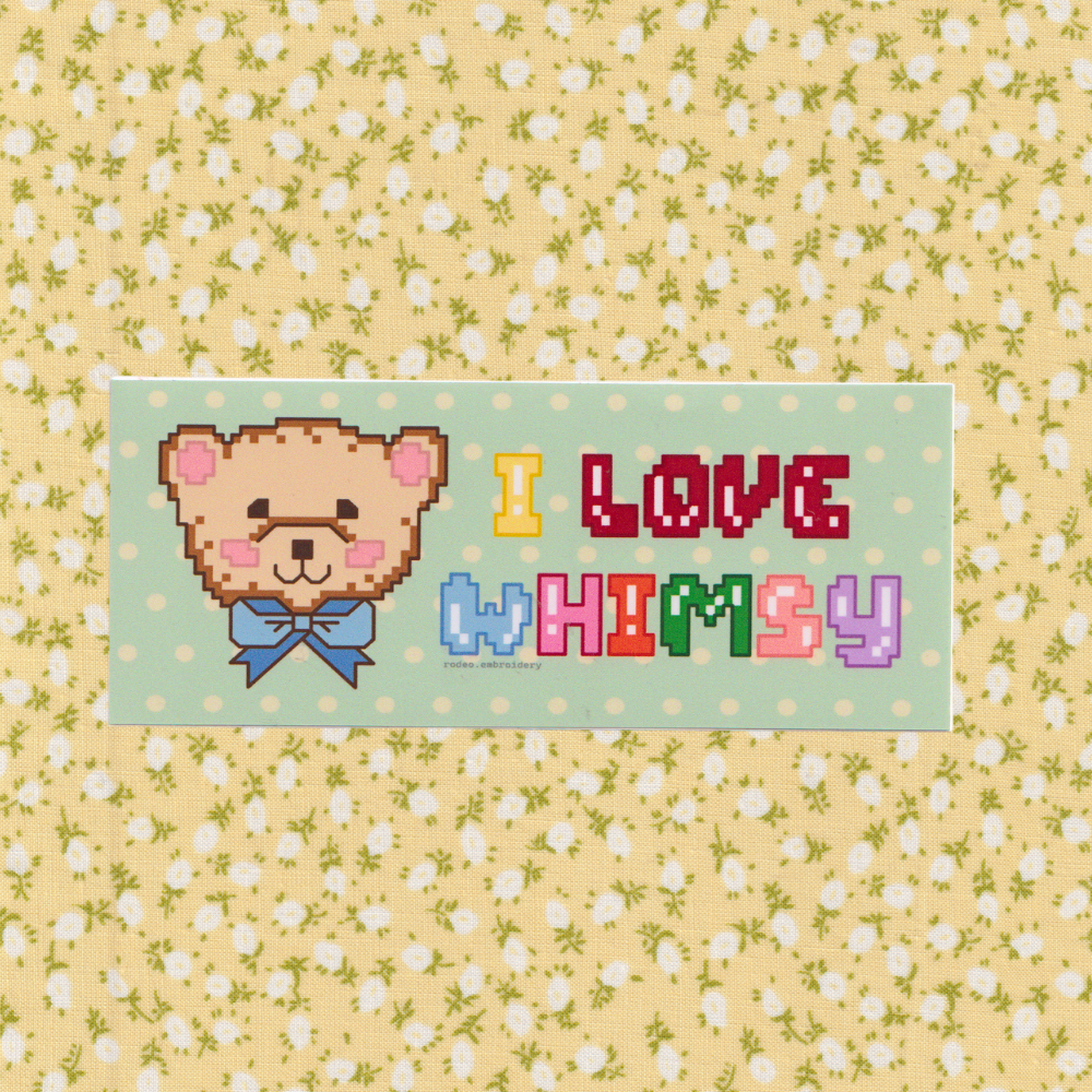 Pixelated bear face sticker with 'I Love Whimsy' text on a floral background