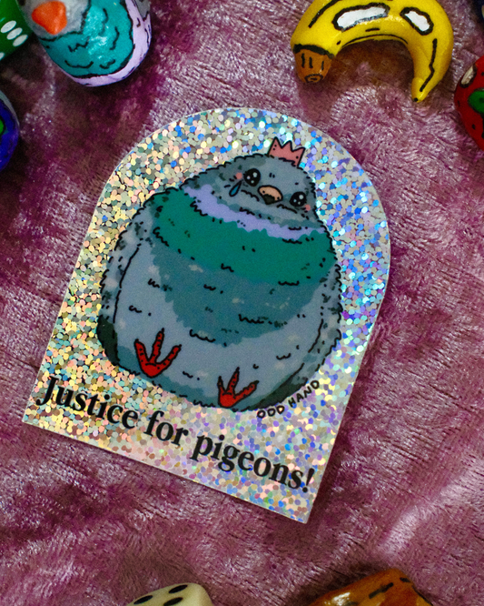 A sticker featuring a cartoon pigeon with the text 'Justice for pigeons!' on a holographic background, placed on a purple textured surface with other colorful objects partially visible around the edges.