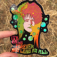 Sticker with colorful design of a person with a bird on their head and text 'It's only forever not long at all' held against a natural background.