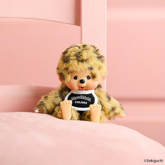 Plush toy with a fur hat and black shirt on a pink background