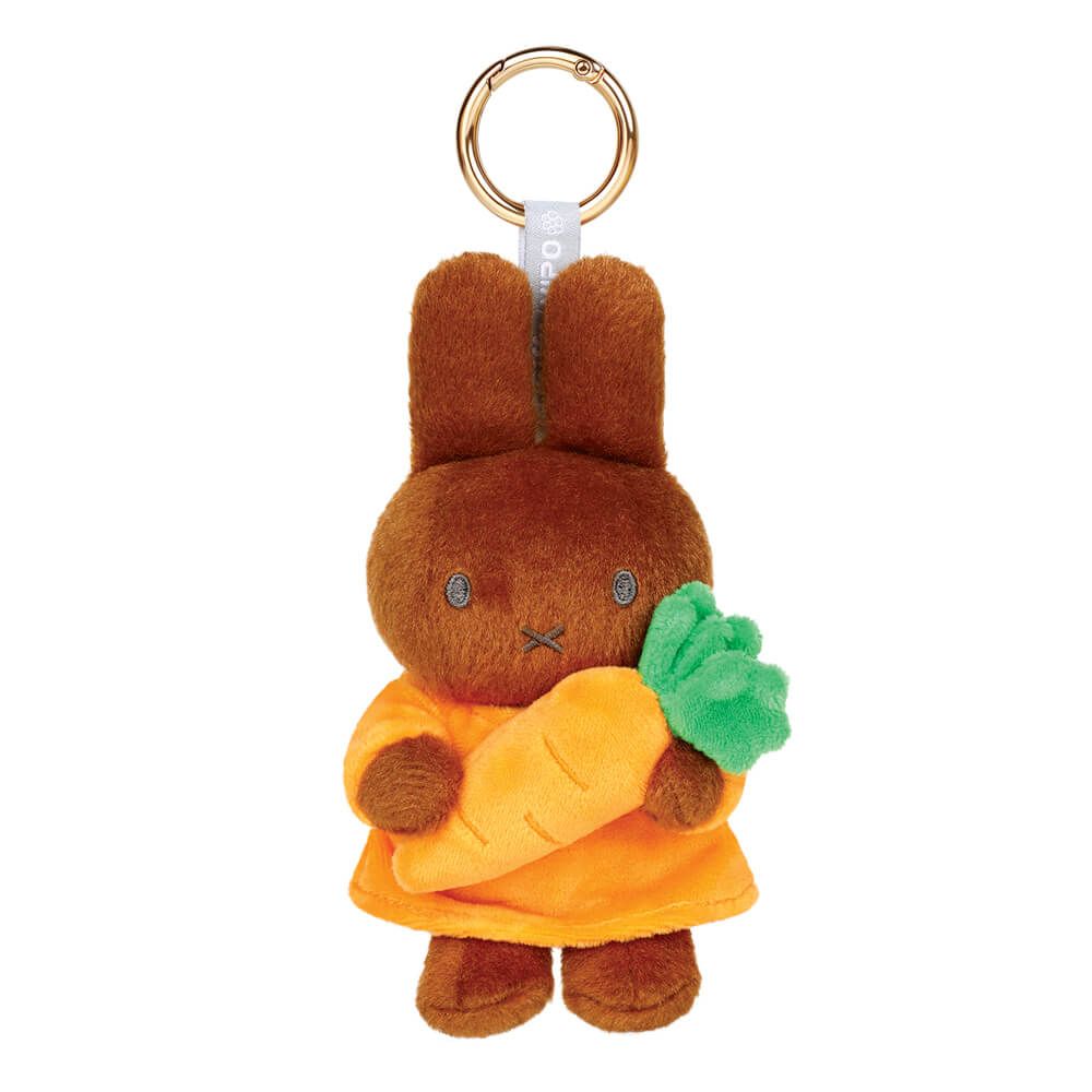 Plush keychain of Melanie holding a carrot on a white background