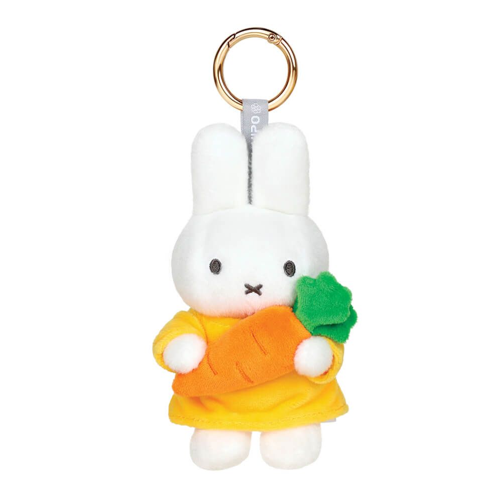 Plush keychain of Miffy character holding a carrot on a white background