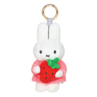 Plush keychain of Miffy holding a red strawberry on a white background