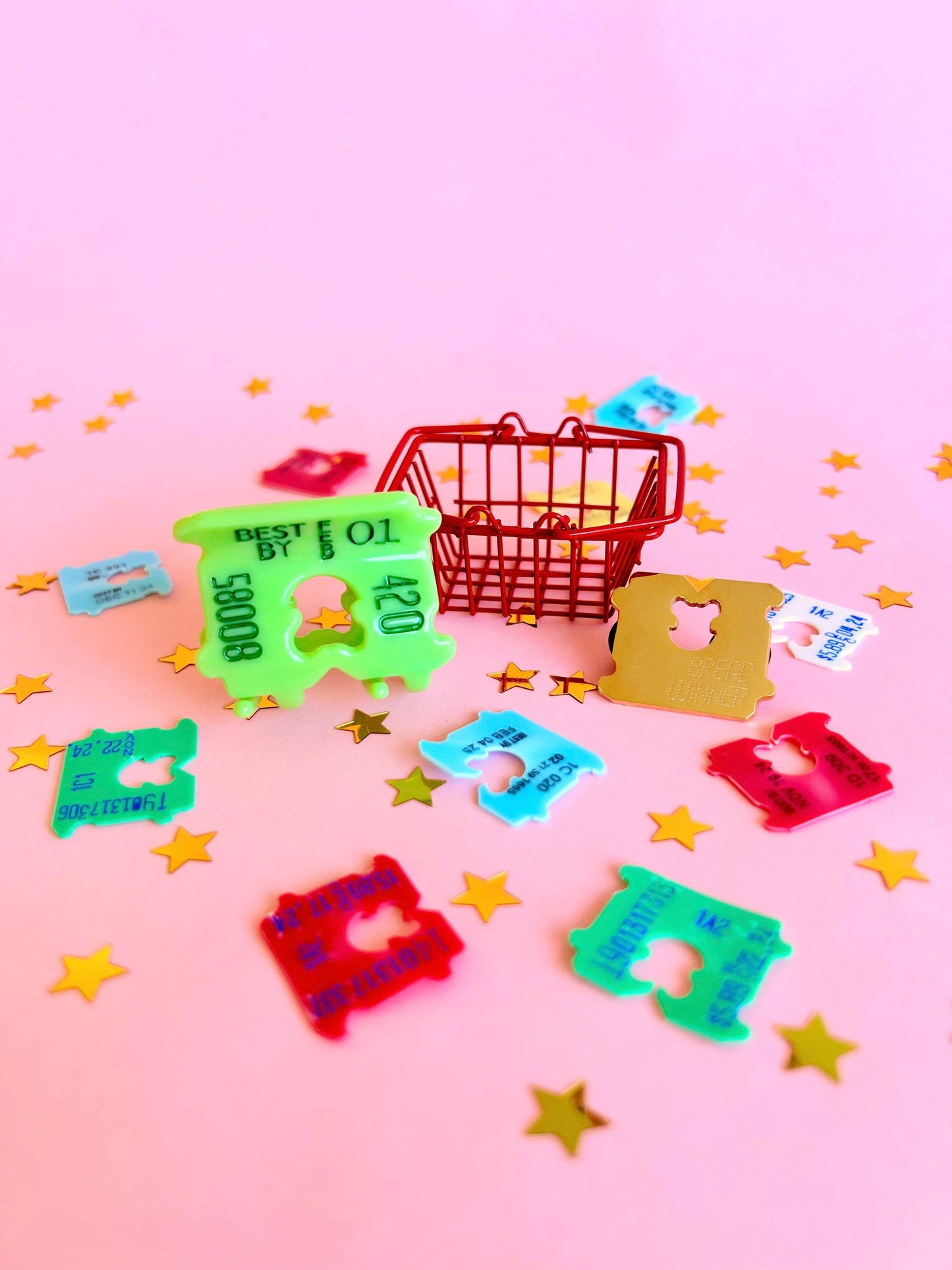 Colorful bread clips on a pink background with star decorations