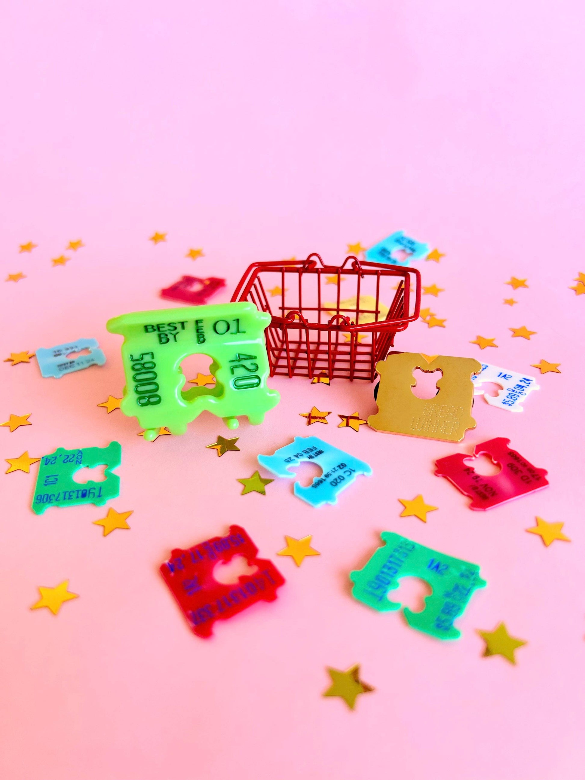 Colorful bread clips on a pink background with star decorations