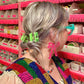 Person with colorful hair clips in a store setting
