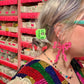 Person with colorful hair and accessories in a store setting