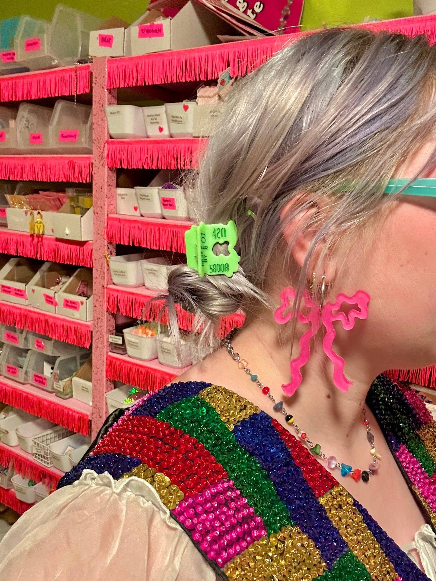 Person with colorful hair and accessories in a store setting
