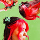 Three perspectives of a person with red and black hair styled with green hair clips on a green background.