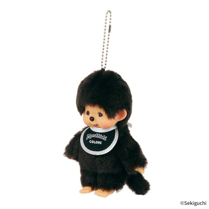 Black Monchhichi plush keychain with a white bib on a white background
