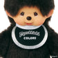 Plush toy with a black bib displaying 'Monchhichi Colors' on a white background