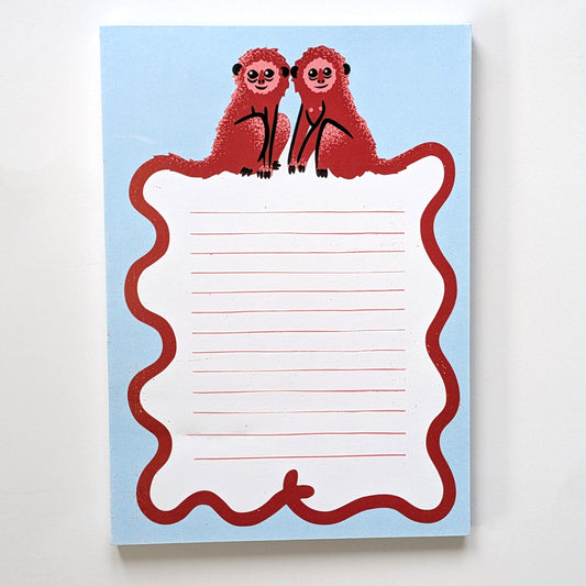 A blue notepad with monkey design on a white background