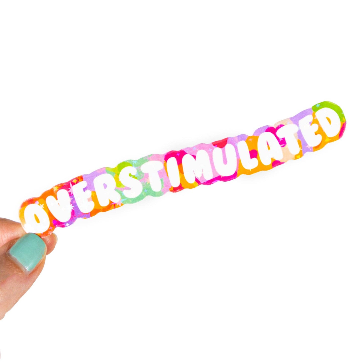 Colorful sticker with 'OVERSTIMULATED' text held by a hand on a white background