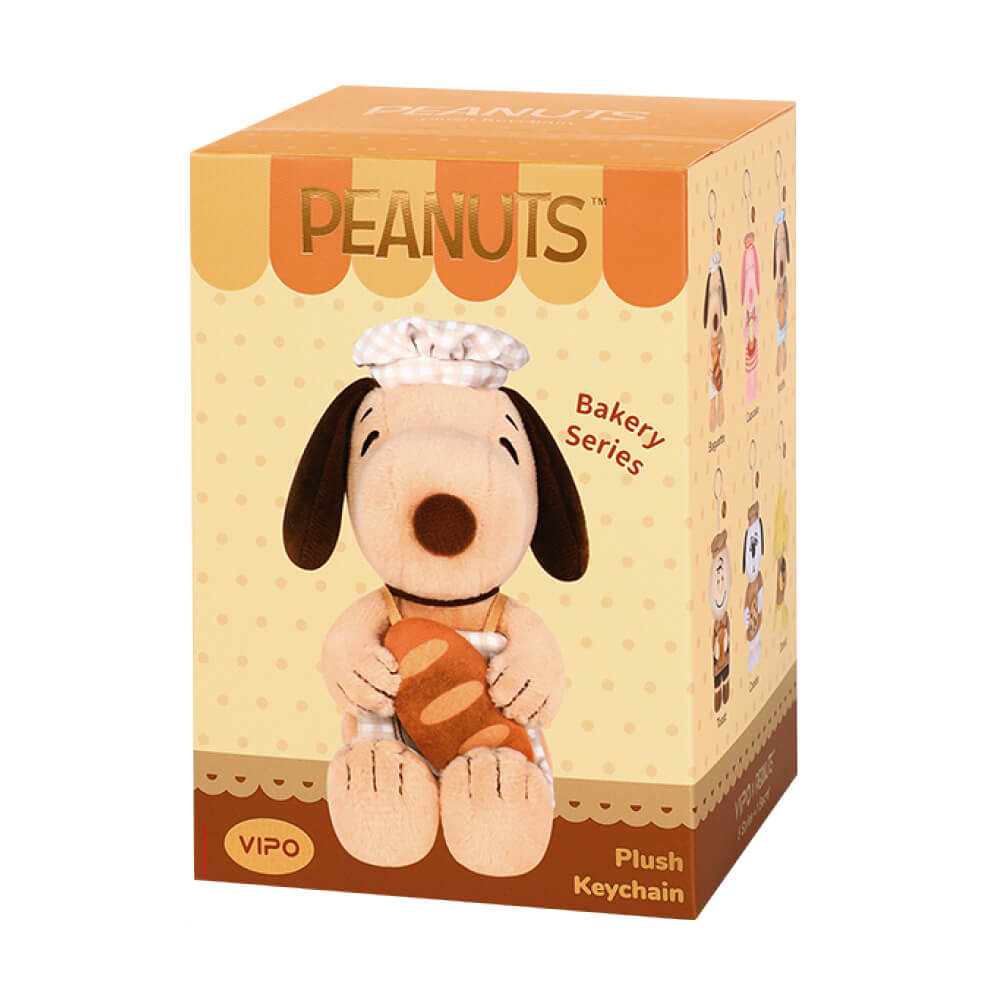 Peanuts plush keychain packaging with a dog character holding bread
