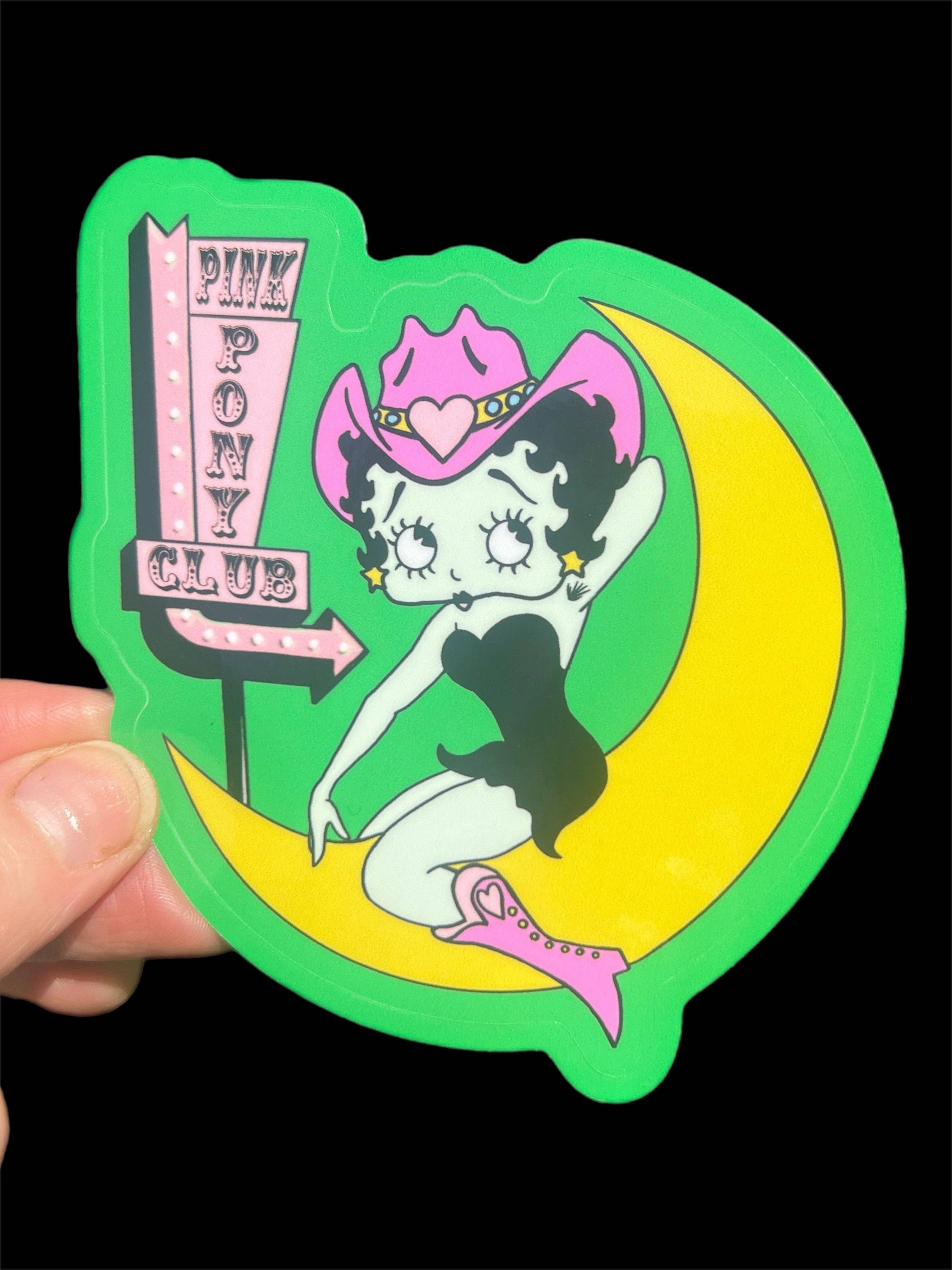 Sticker of betty boop 'Pink Pony Club' on a crescent moon with a pink pony club sign.